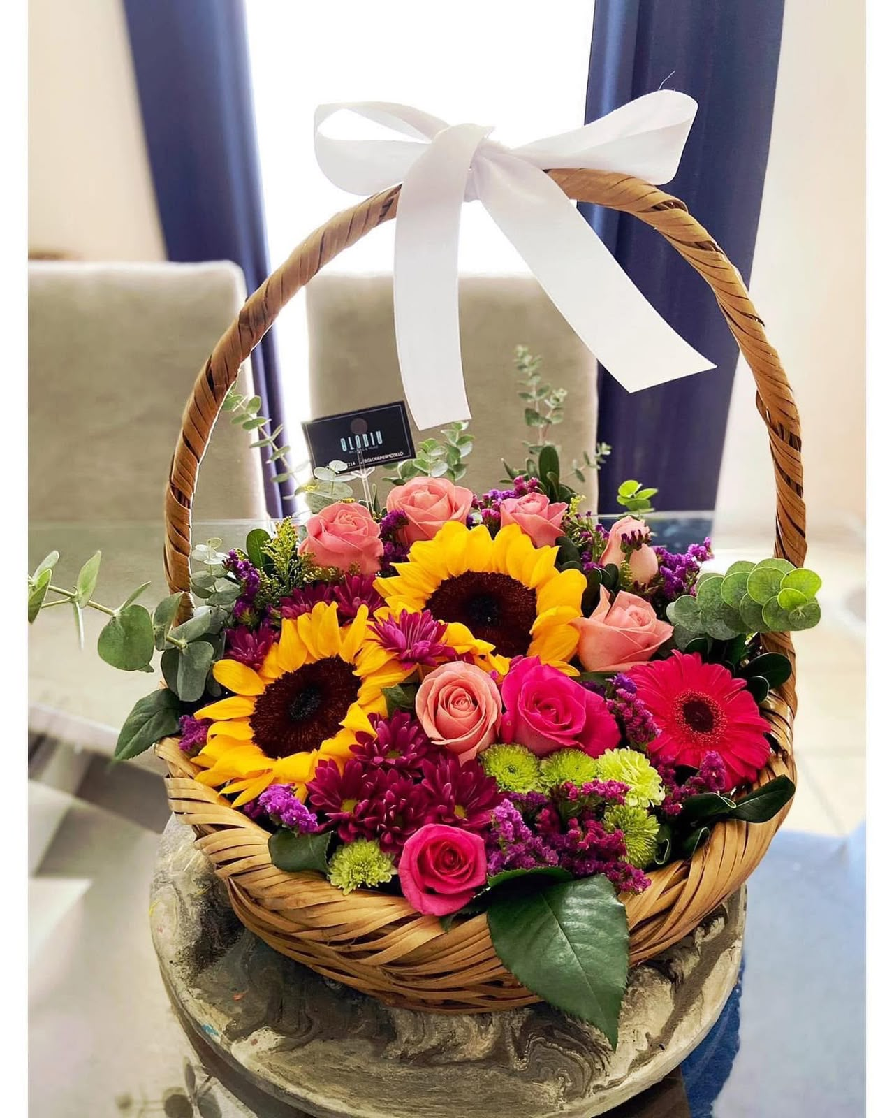 Canasta de girasoles, rosas, gerberas y follaje verde